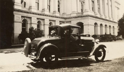 Automobile parked in front of the West side of the State Capitol building in 1929