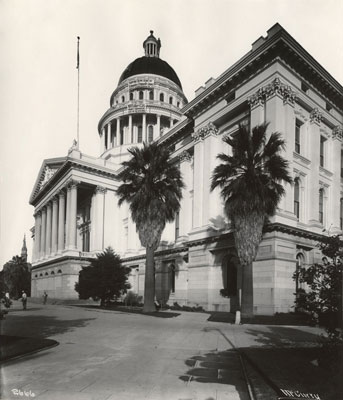 Southwest side of the State Capitol with men painting the dome circa 1910