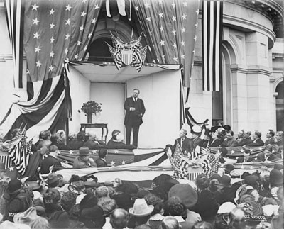 Theodore Roosevelt outside the east side of the State Capitol addressing a crowd circa 1903